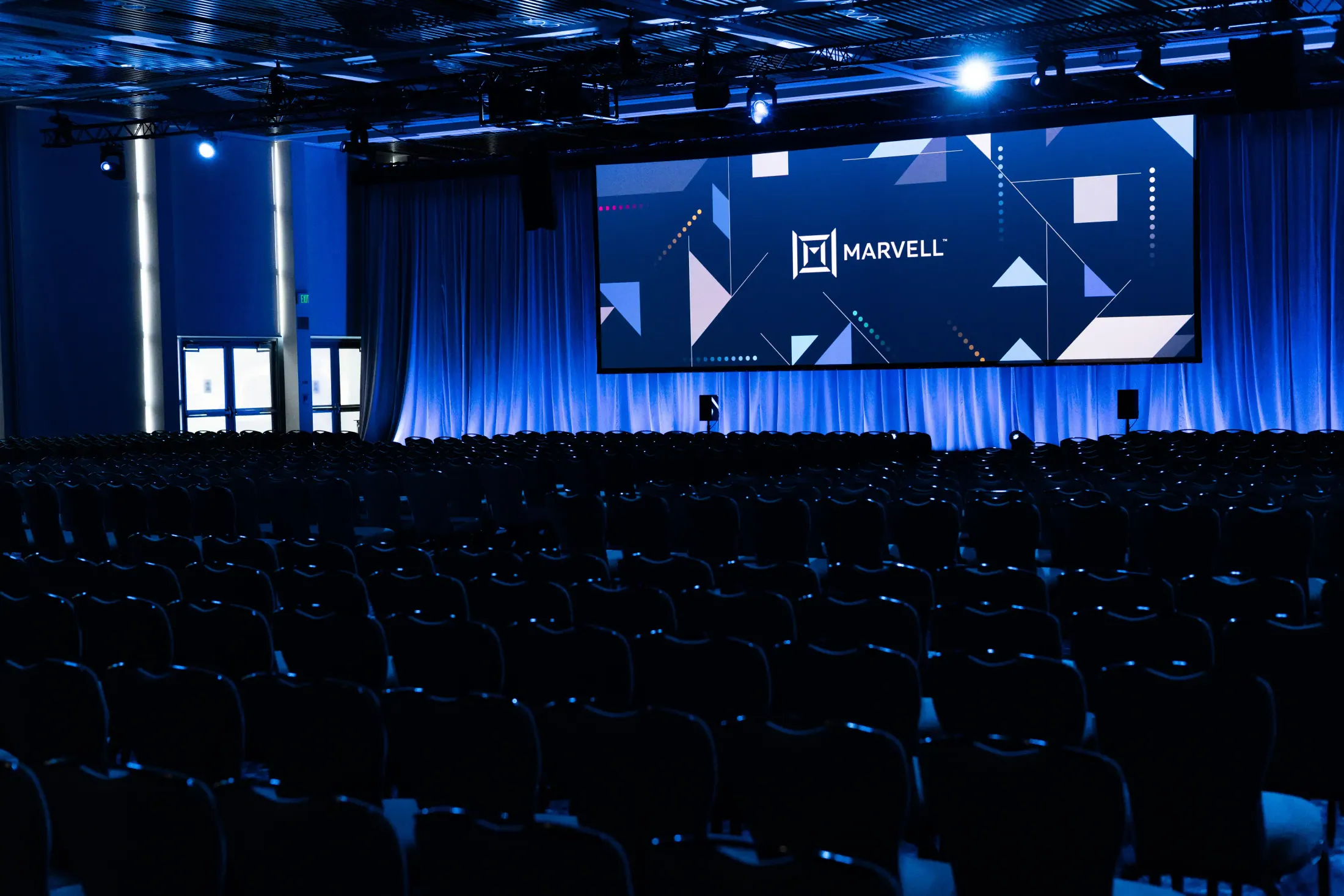 All Employee Meeting stage with branded display.