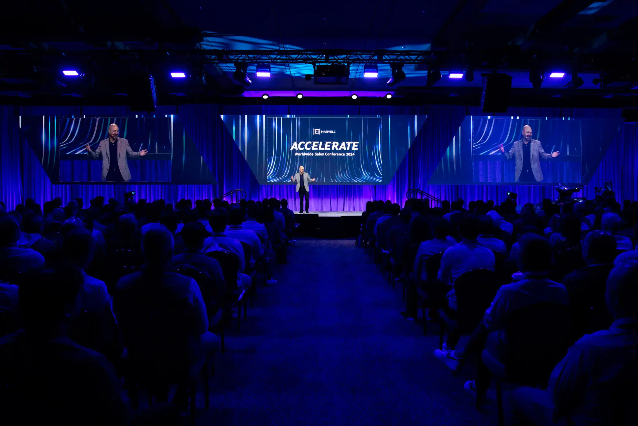 Sales Conference stage with branded screen.