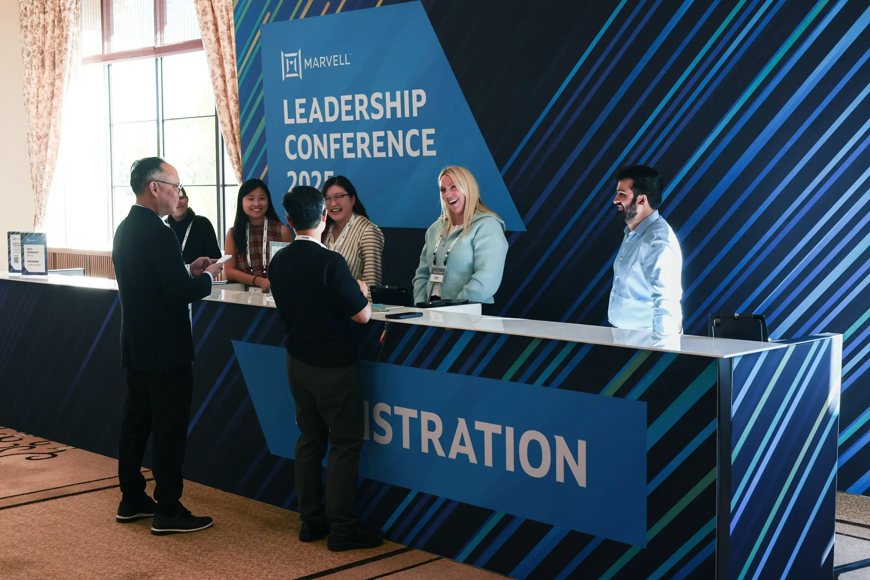 Large branded registration desk for leadership attendees.