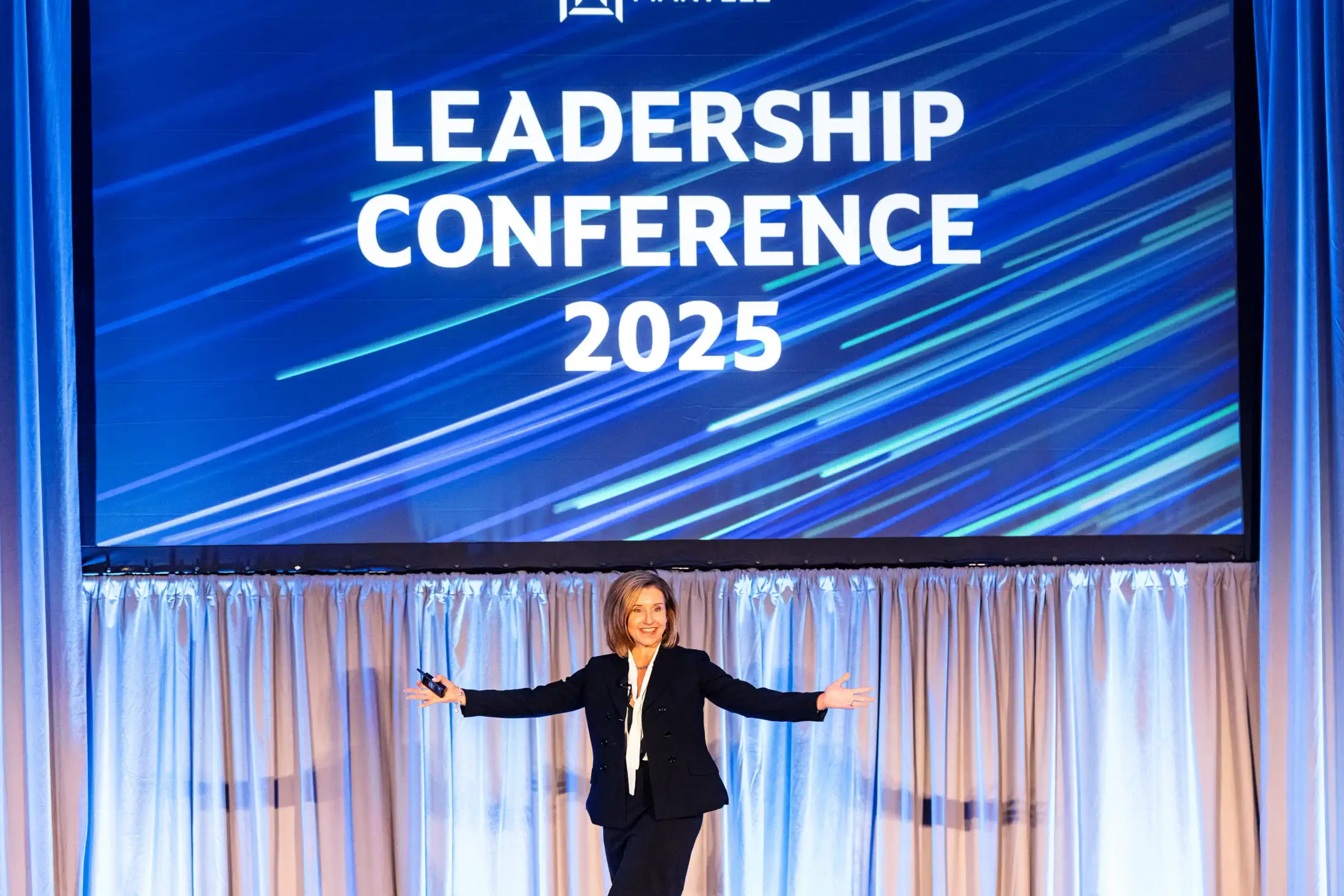 Speaker presenting on stage at the Marvell Leadership Conference.